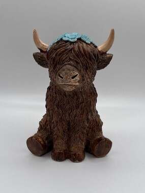 Gerson Sitting Resin Highland Cow Figurine with Blue Flower Crown